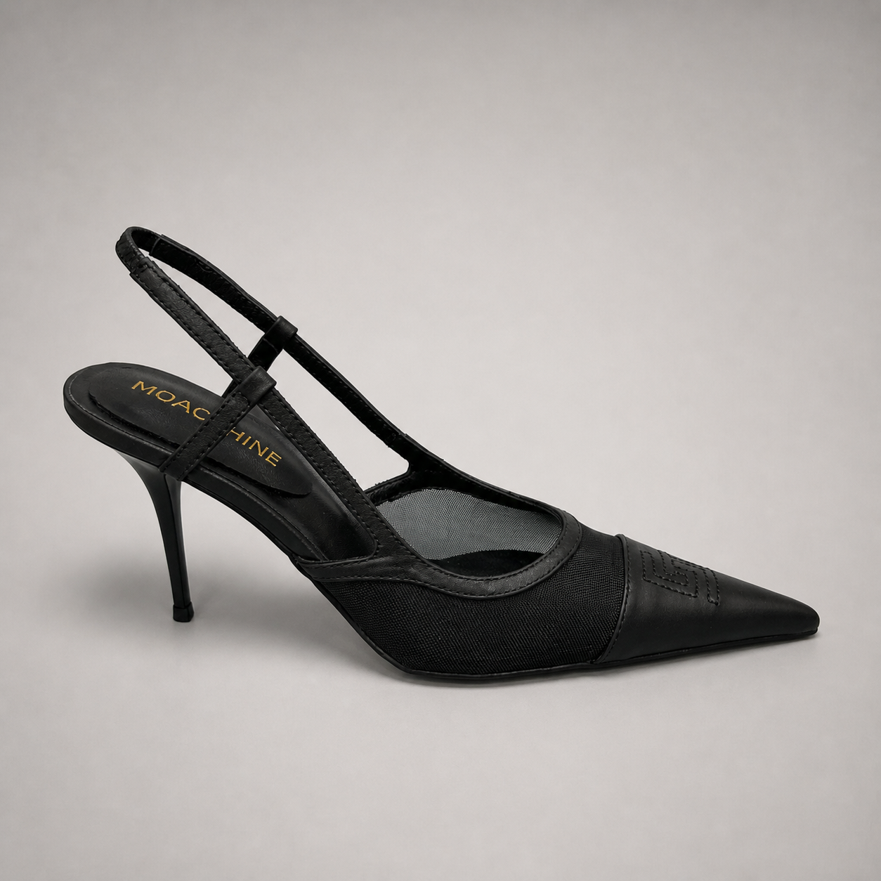 Black slingback pump side profile showing a pointed toe and lace-panel upper