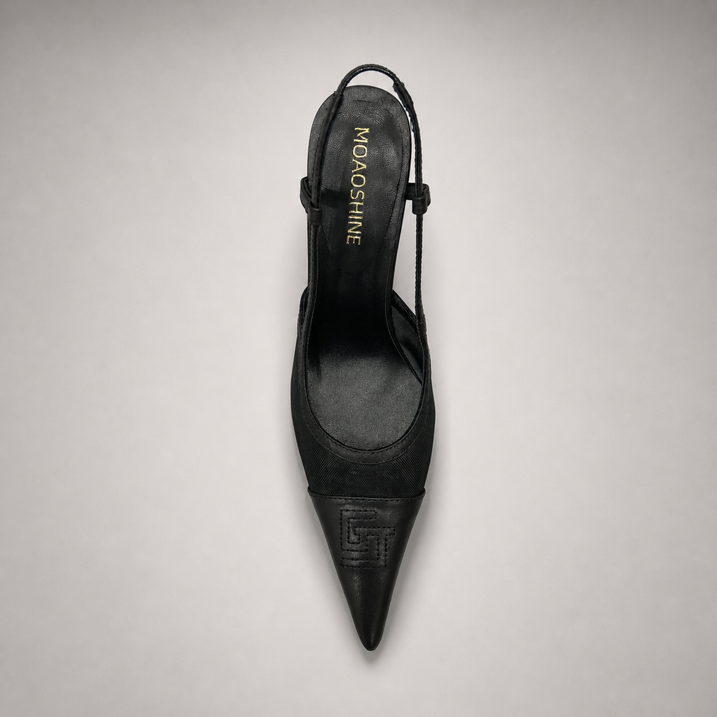Black slingback pump top view showing a pointed toe and lace-panel upper