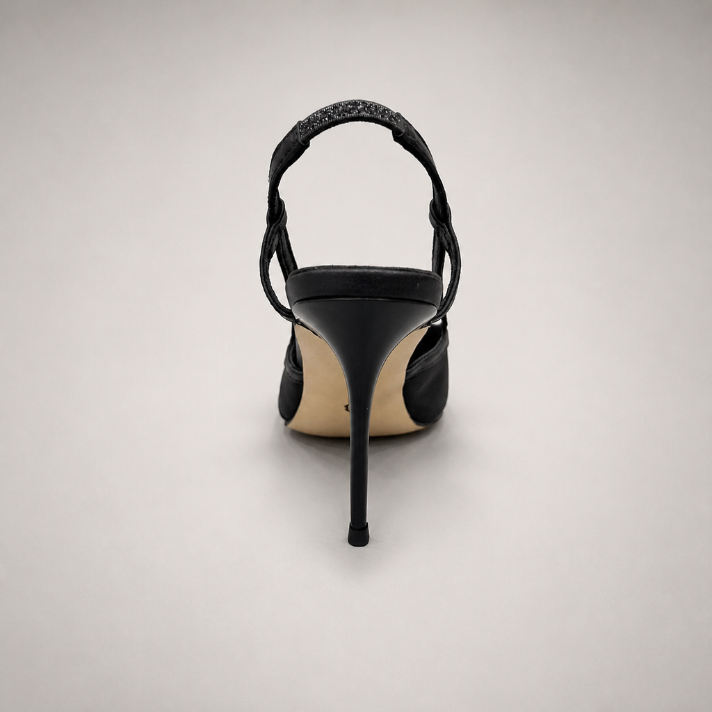 Black slingback pump rear view showing a pointed toe and lace-panel upper