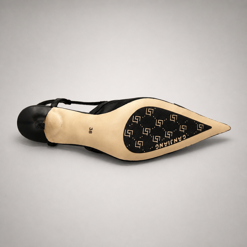 Black slingback pump outsole view showing the cow leather outsole