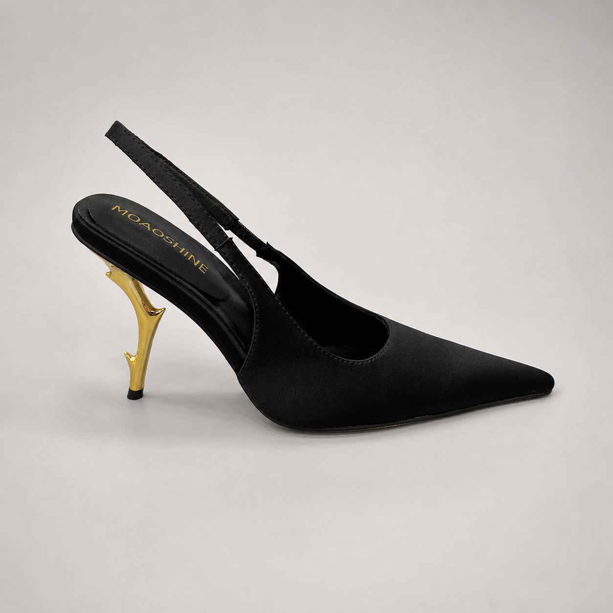 Black slingback pump side profile showing a pointed toe and sculpted heel