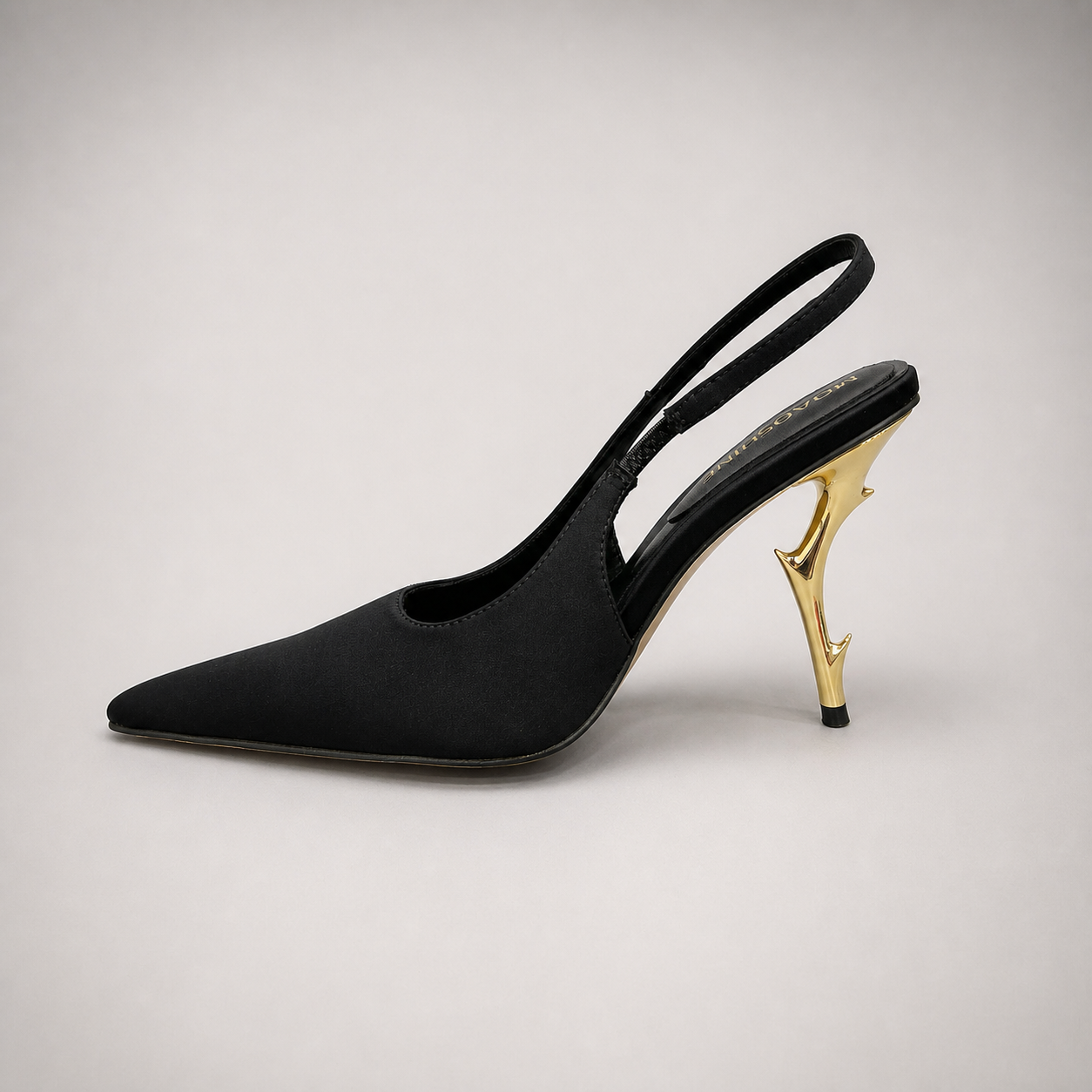 Black slingback pump opposite side profile showing a pointed toe and sculpted heel