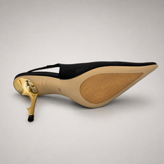Black slingback pump rear view showing a pointed toe and sculpted heel