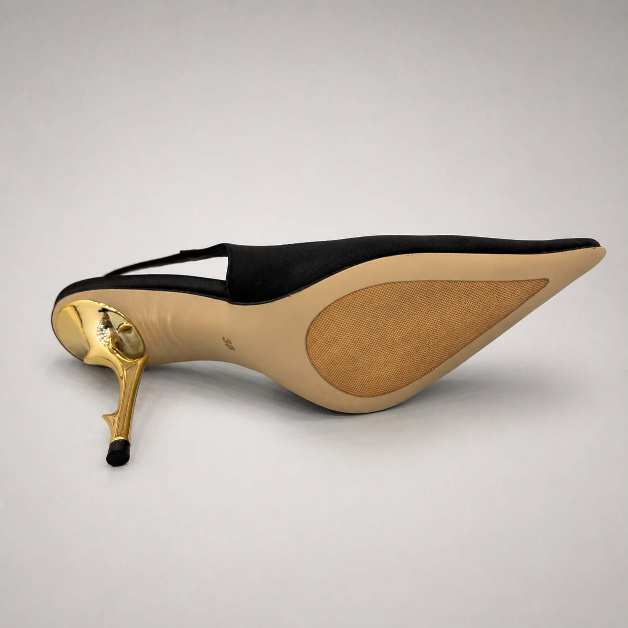 Black slingback pump rear view showing a pointed toe and sculpted heel