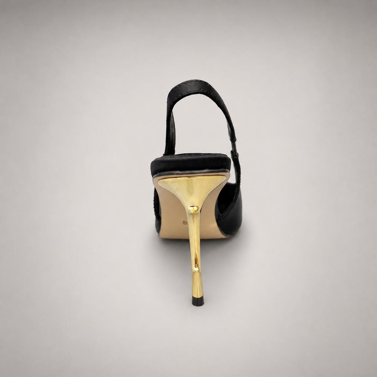 Black slingback pump top view showing a pointed toe and sculpted heel