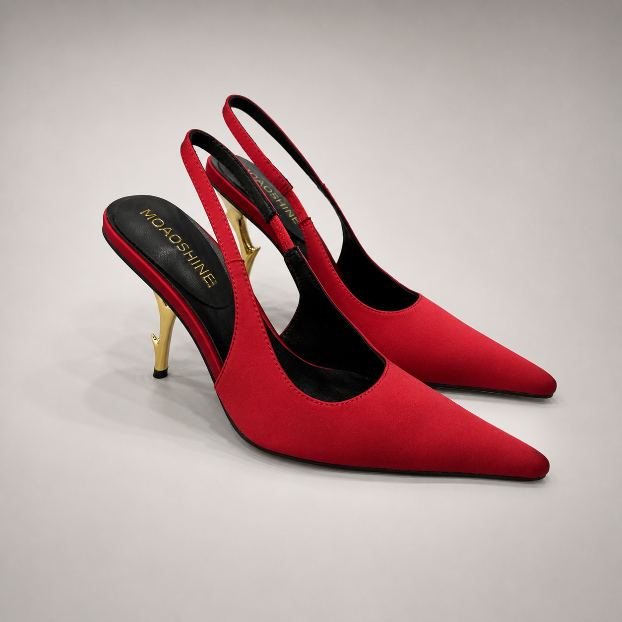Red slingback pump pair three-quarter view showing a pointed toe and sculpted heel