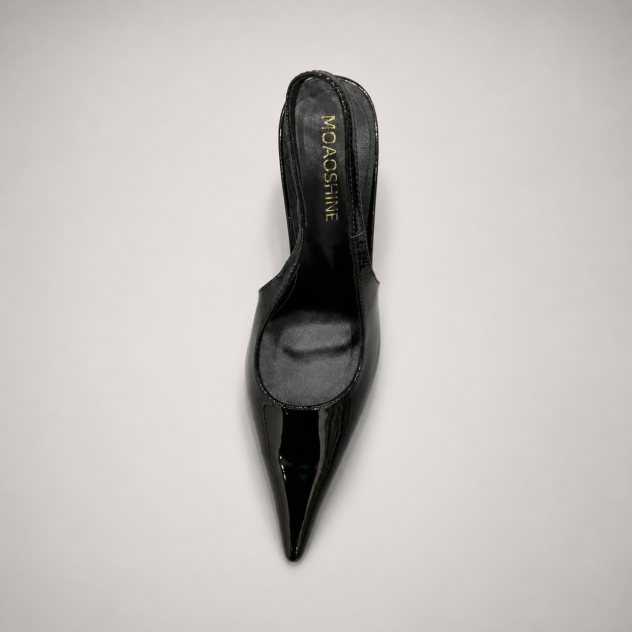 Black slingback pump opposite side profile showing a pointed toe and sculpted heel