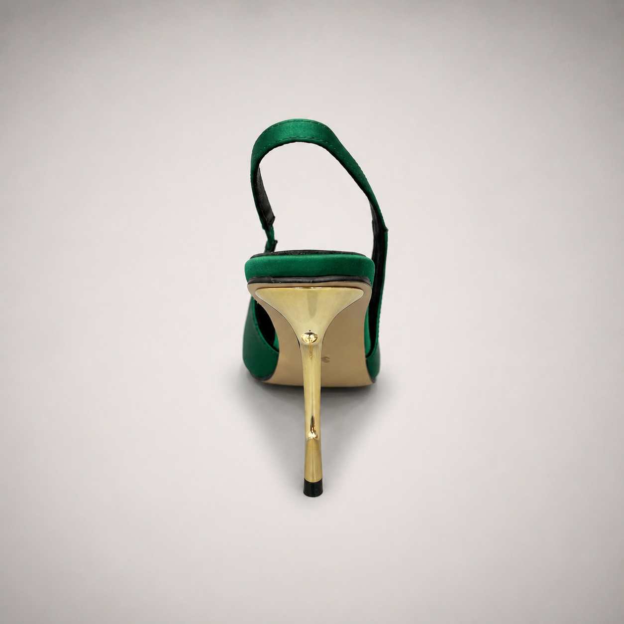 Green slingback pump rear view showing a pointed toe and sculpted heel