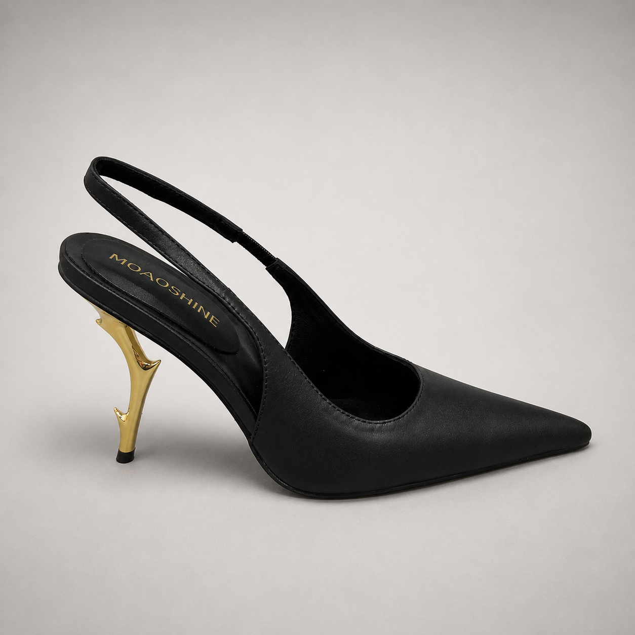 Black slingback pump side profile showing a pointed toe and sculpted heel
