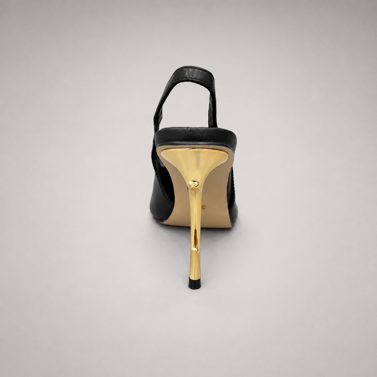 Black slingback pump rear view showing a pointed toe and sculpted heel
