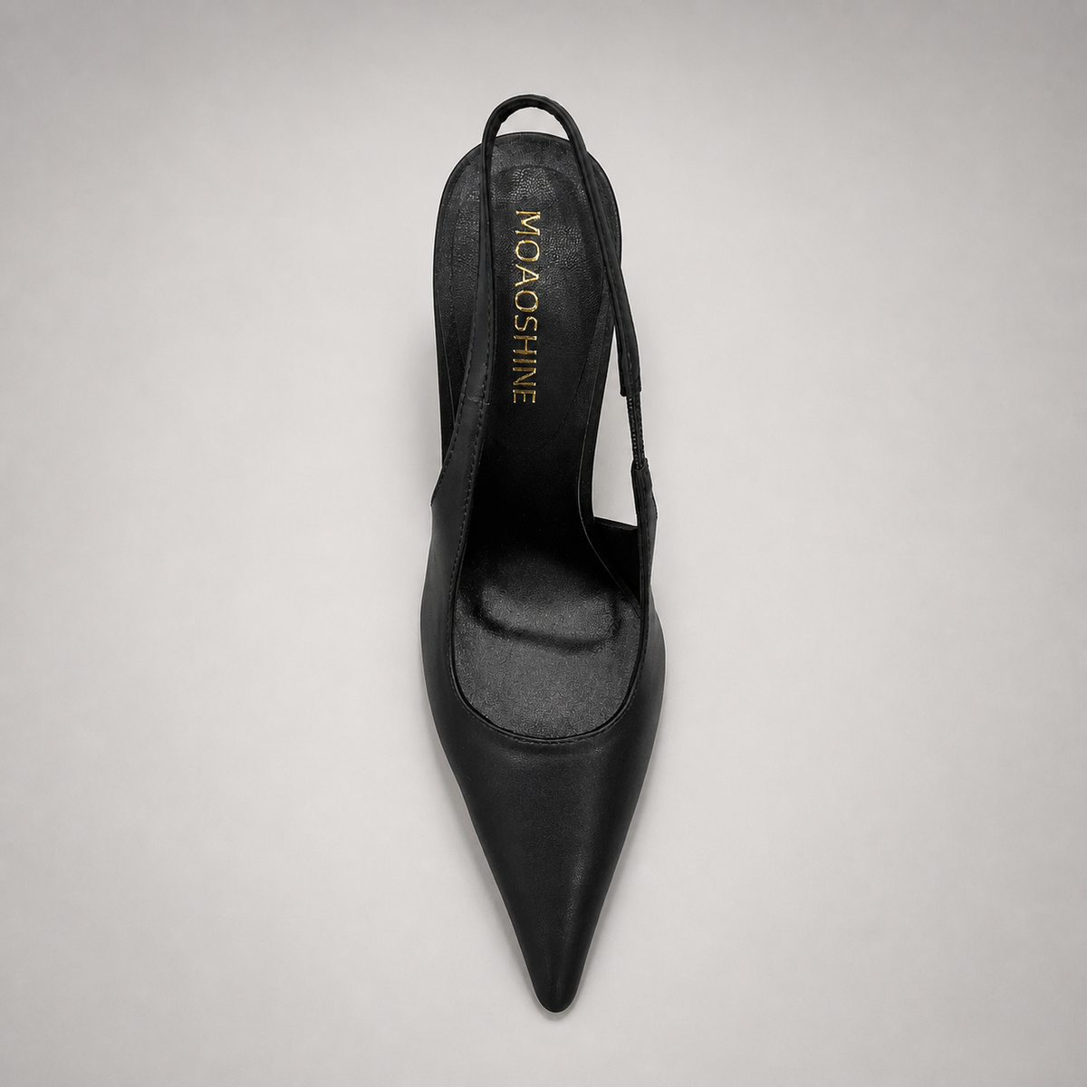 Black slingback pump top view showing a pointed toe and sculpted heel