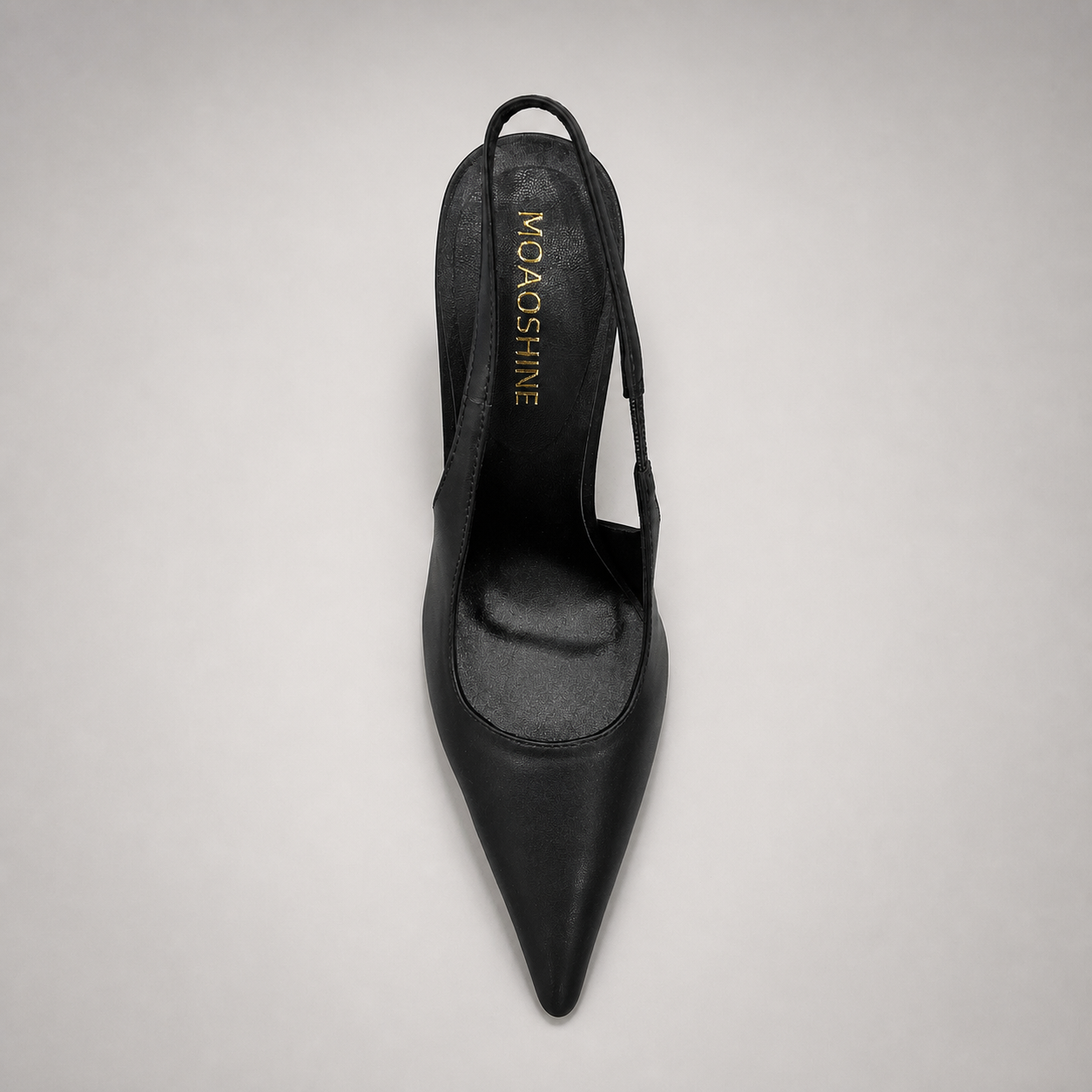 Black slingback pump top view showing a pointed toe and sculpted heel