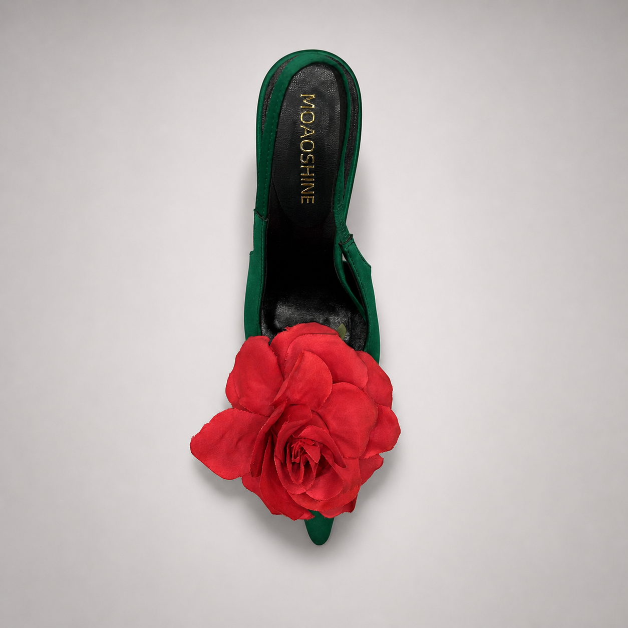 Green slingback pump rear view showing a pointed toe and floral appliqué