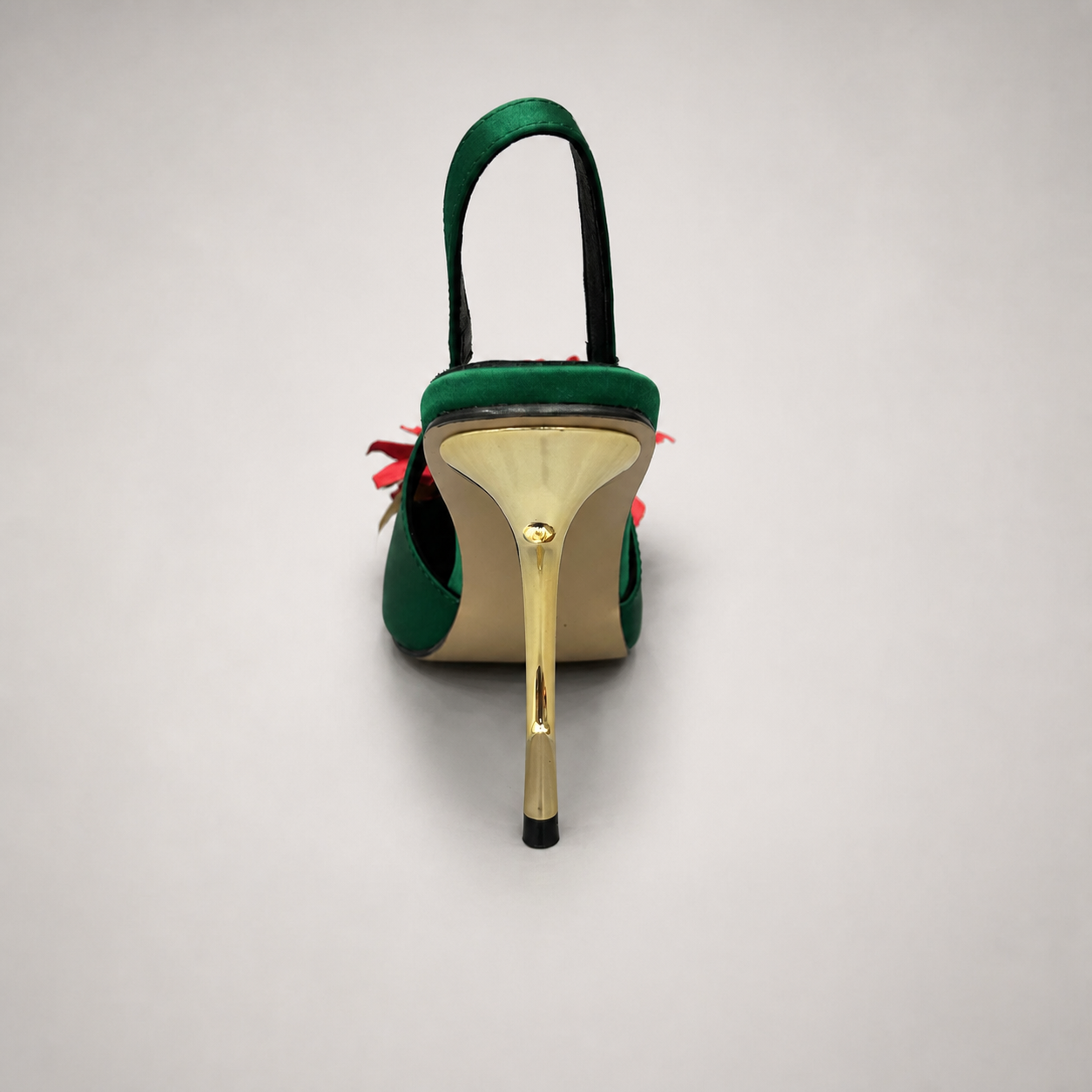 Green slingback pump top view showing a pointed toe and floral appliqué