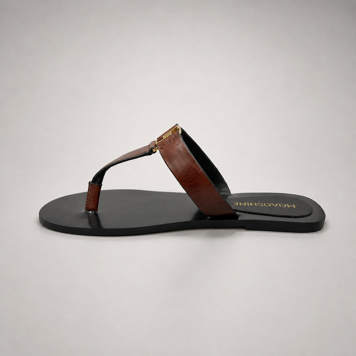 Brown flat sandal opposite side profile showing a flat sole with a toe-loop strap