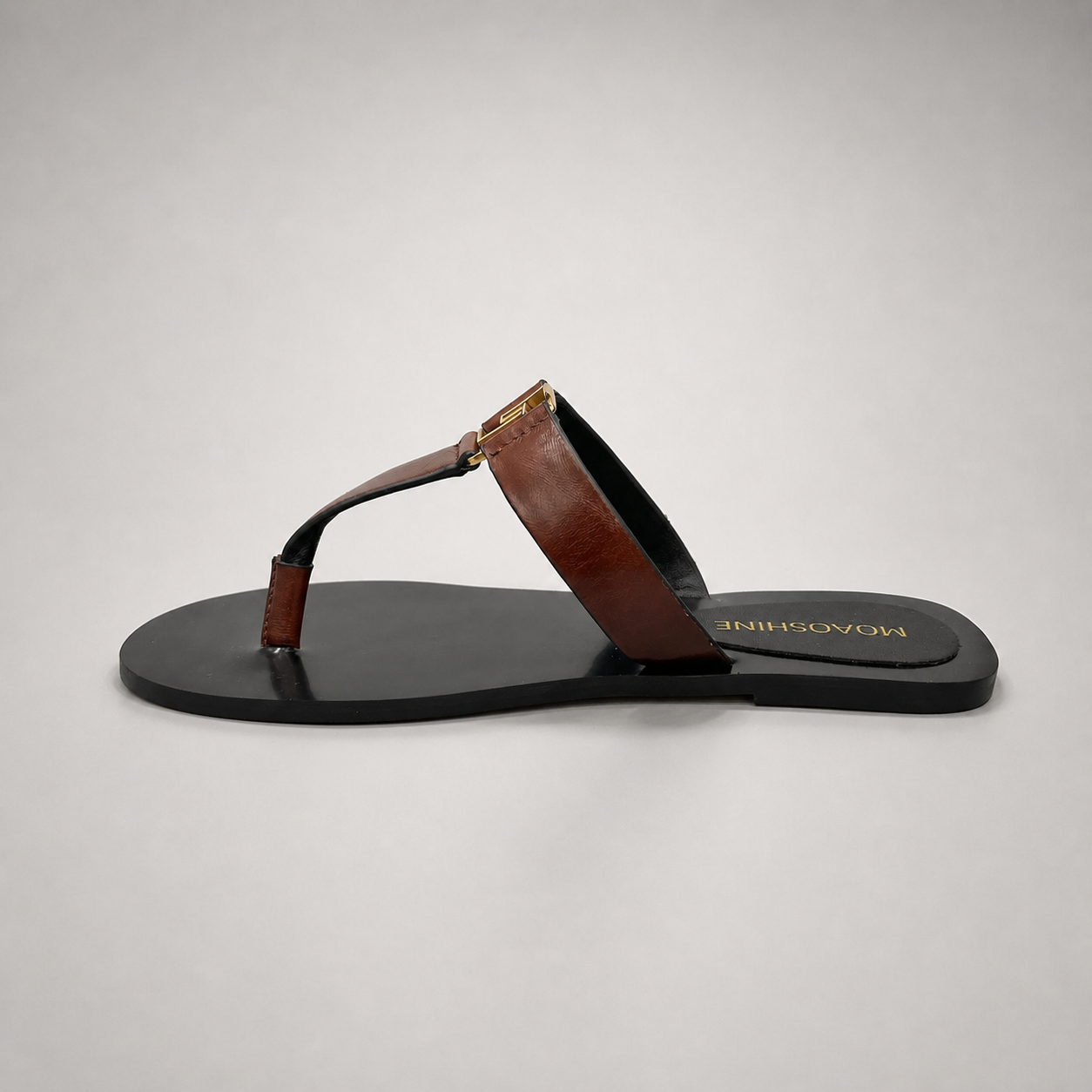 Brown flat sandal opposite side profile showing a flat sole with a toe-loop strap
