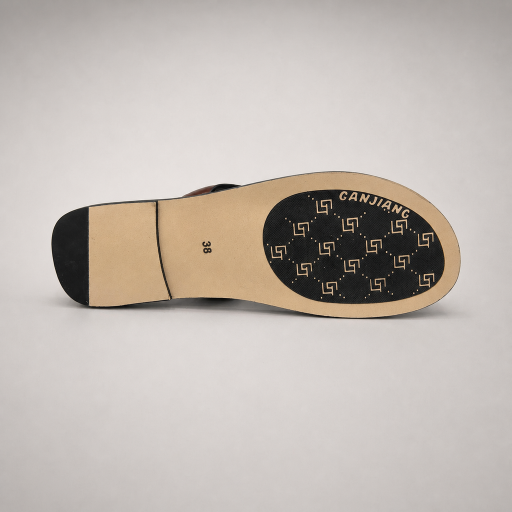 Brown flat sandal top view showing a flat sole with a toe-loop strap