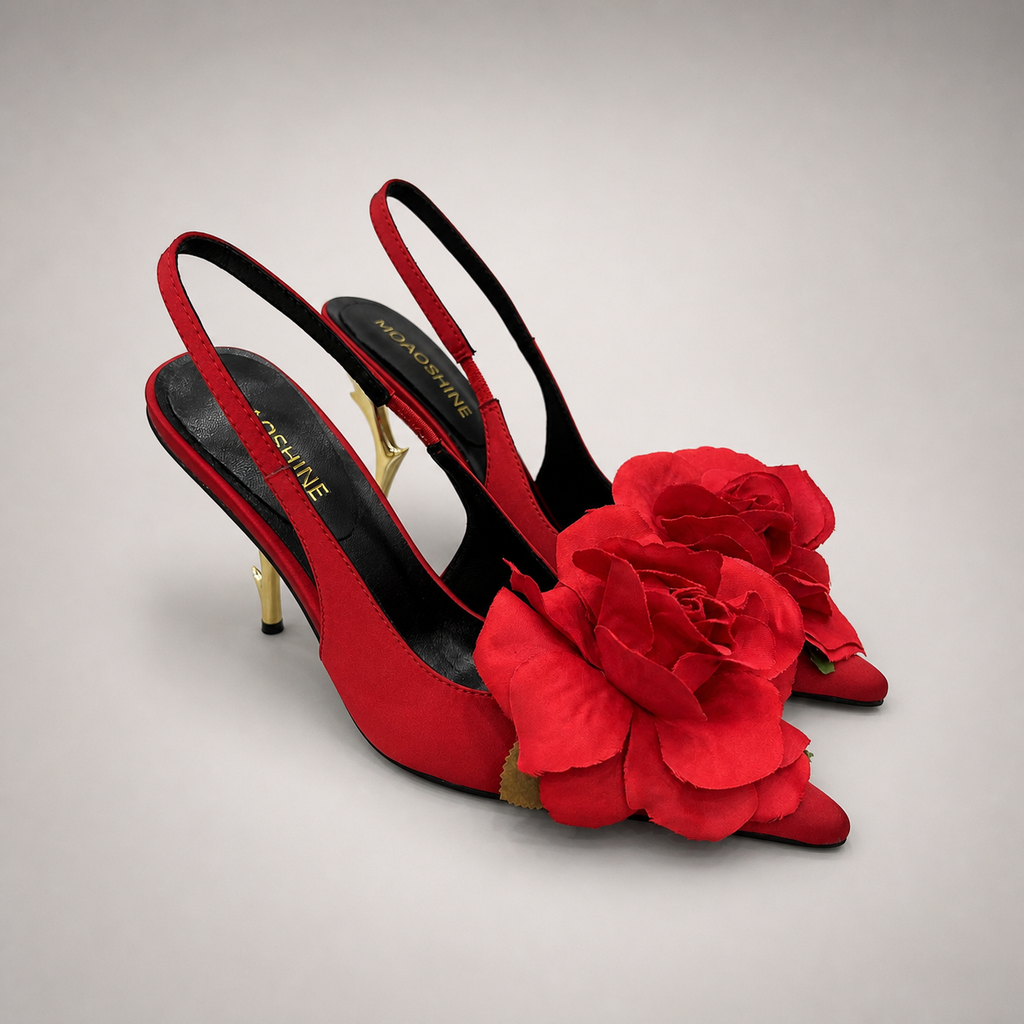 Red slingback pump pair three-quarter view showing a pointed toe and floral appliqué
