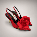 Red slingback pump pair three-quarter view showing a pointed toe and floral appliqué
