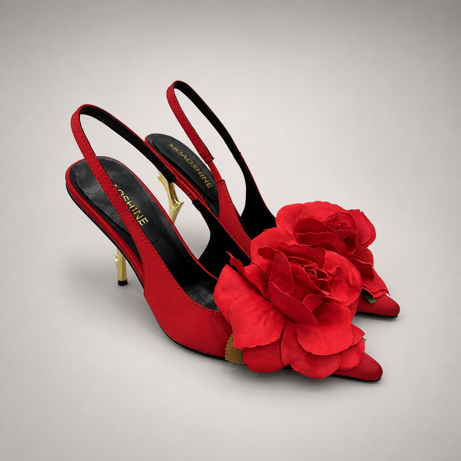 Red slingback pump pair three-quarter view showing a pointed toe and floral appliqu¨¦