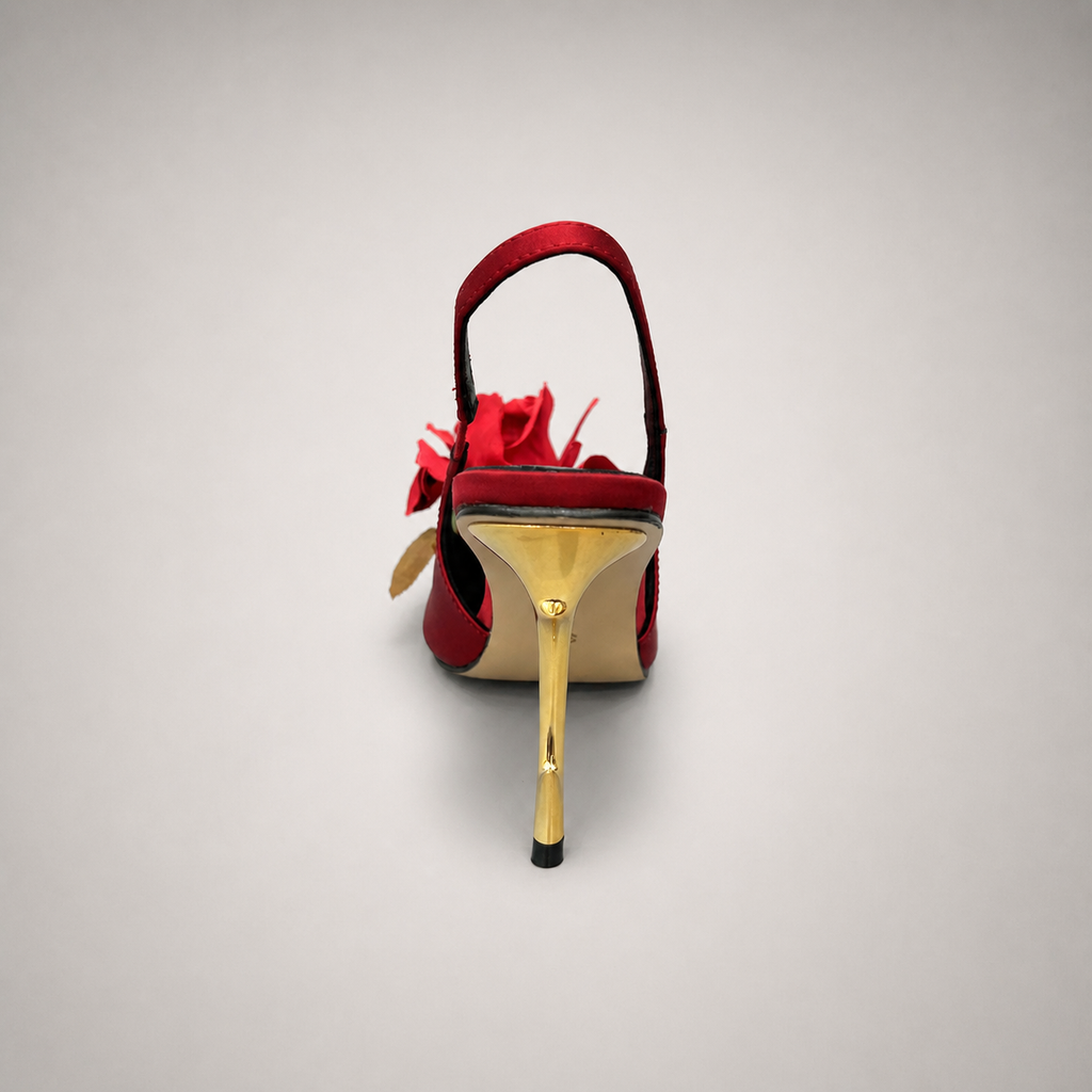 Red slingback pump top view showing a pointed toe and floral appliqué
