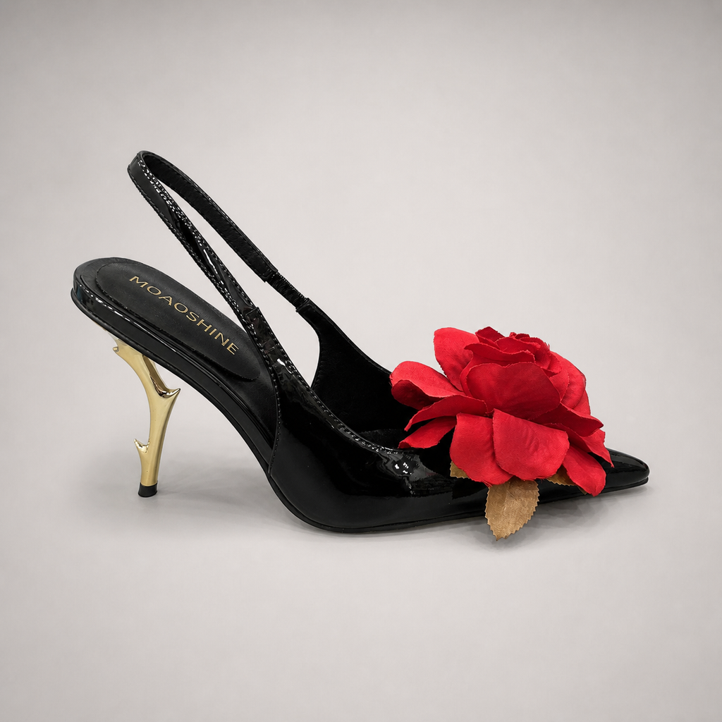 Black slingback pump side profile showing a pointed toe and floral appliqué