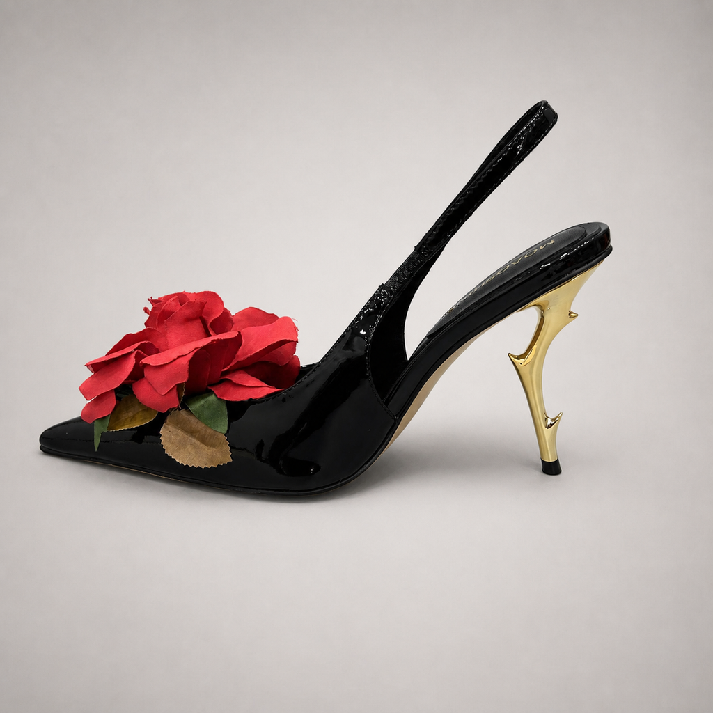 Black slingback pump opposite side profile showing a pointed toe and floral appliqué