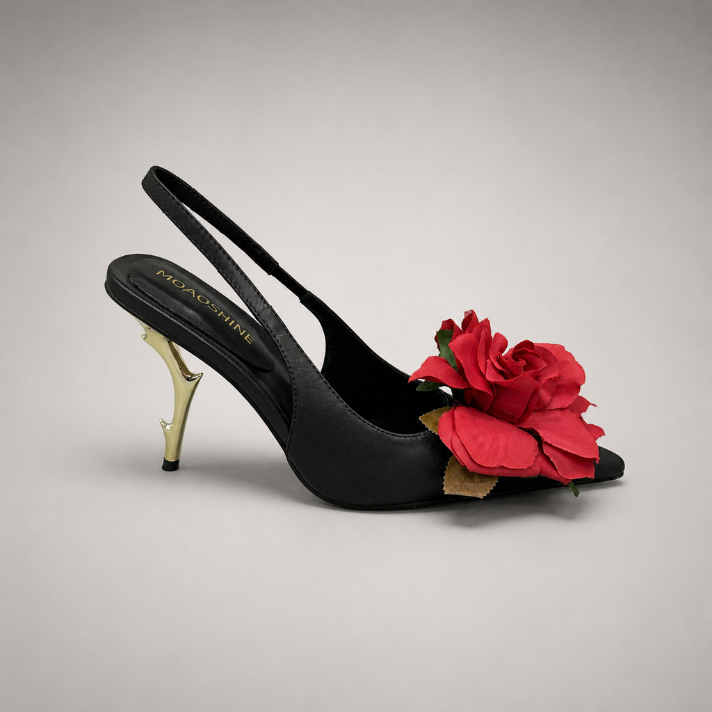 Black slingback pump side profile showing a pointed toe and floral appliqué