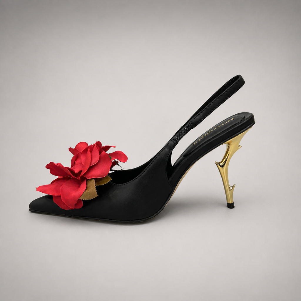 Black slingback pump opposite side profile showing a pointed toe and floral appliqué