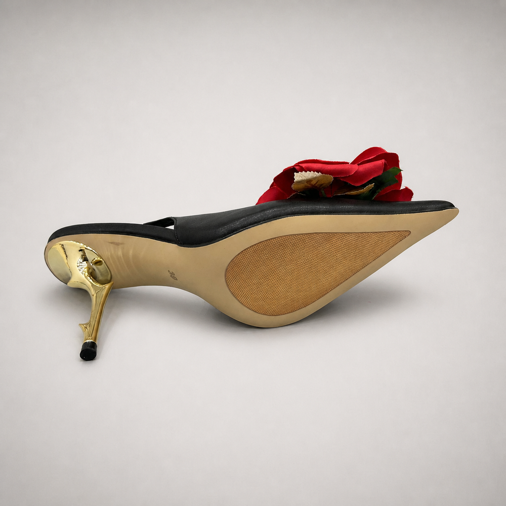 Black slingback pump top view showing a pointed toe and floral appliqué