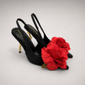 Black slingback pump pair three-quarter view showing a pointed toe and floral appliqué