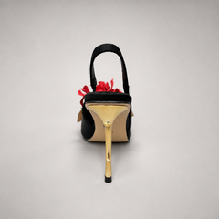 Black slingback pump rear view showing a pointed toe and floral appliqu¨¦