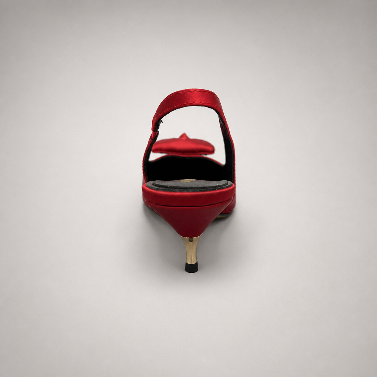 Red slingback pump rear view showing a pointed toe and bow detail