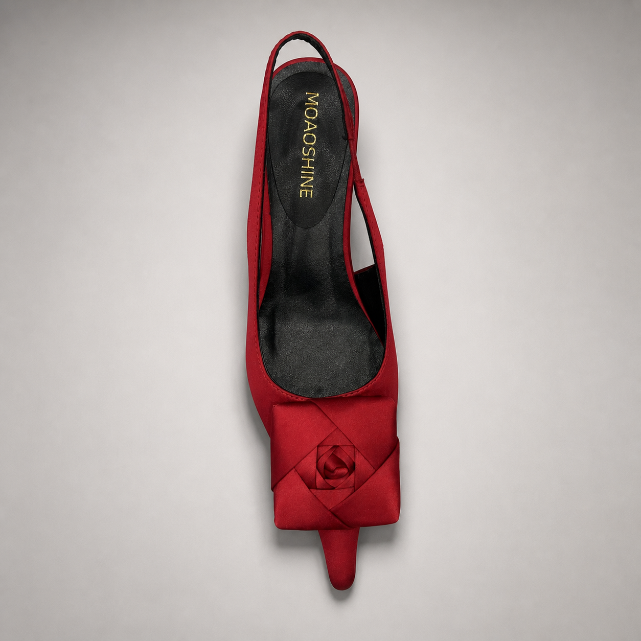 Red slingback pump top view showing a pointed toe and bow detail