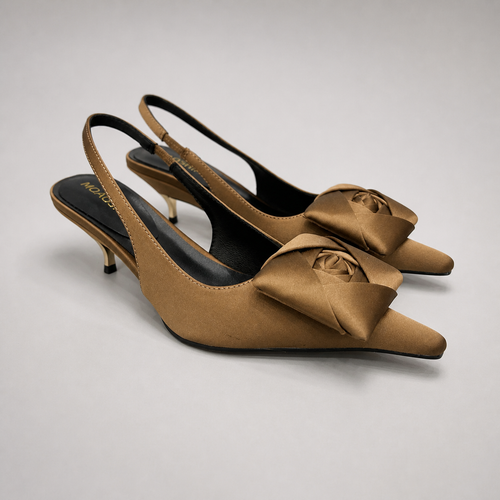 Brown slingback pump pair three-quarter view showing a pointed toe and bow detail