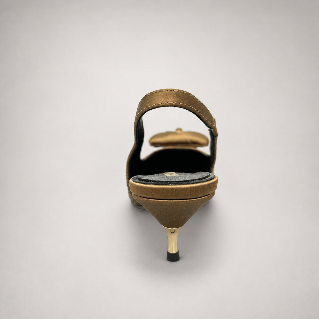 Brown slingback pump rear view showing a pointed toe and bow detail