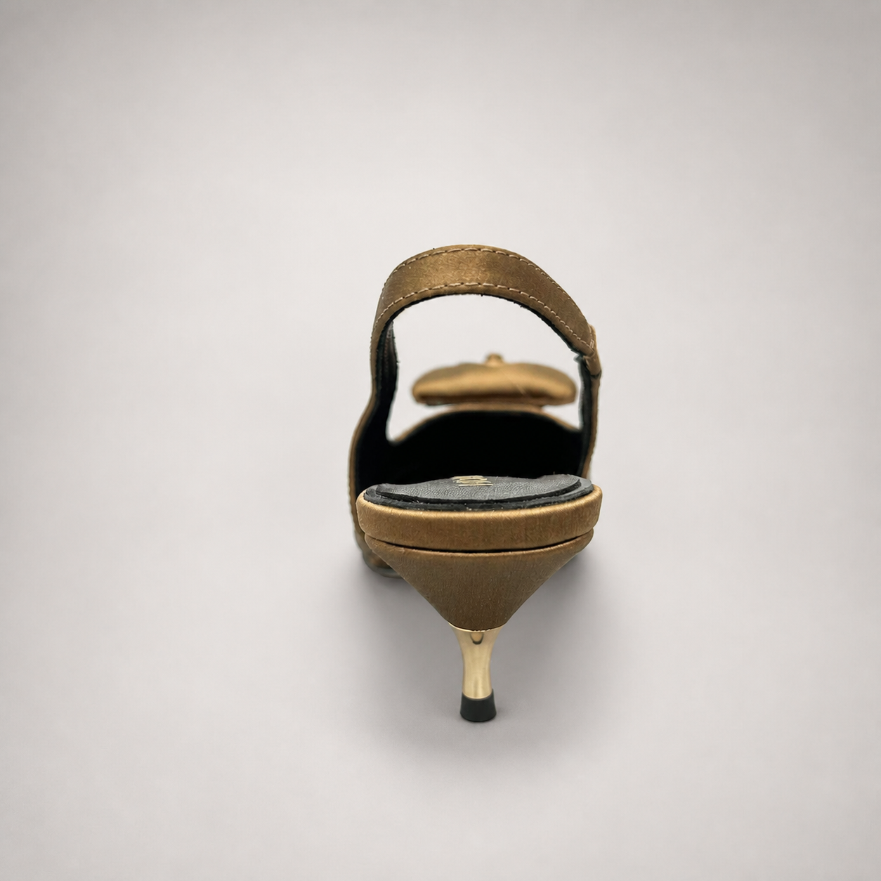 Brown slingback pump rear view showing a pointed toe and bow detail