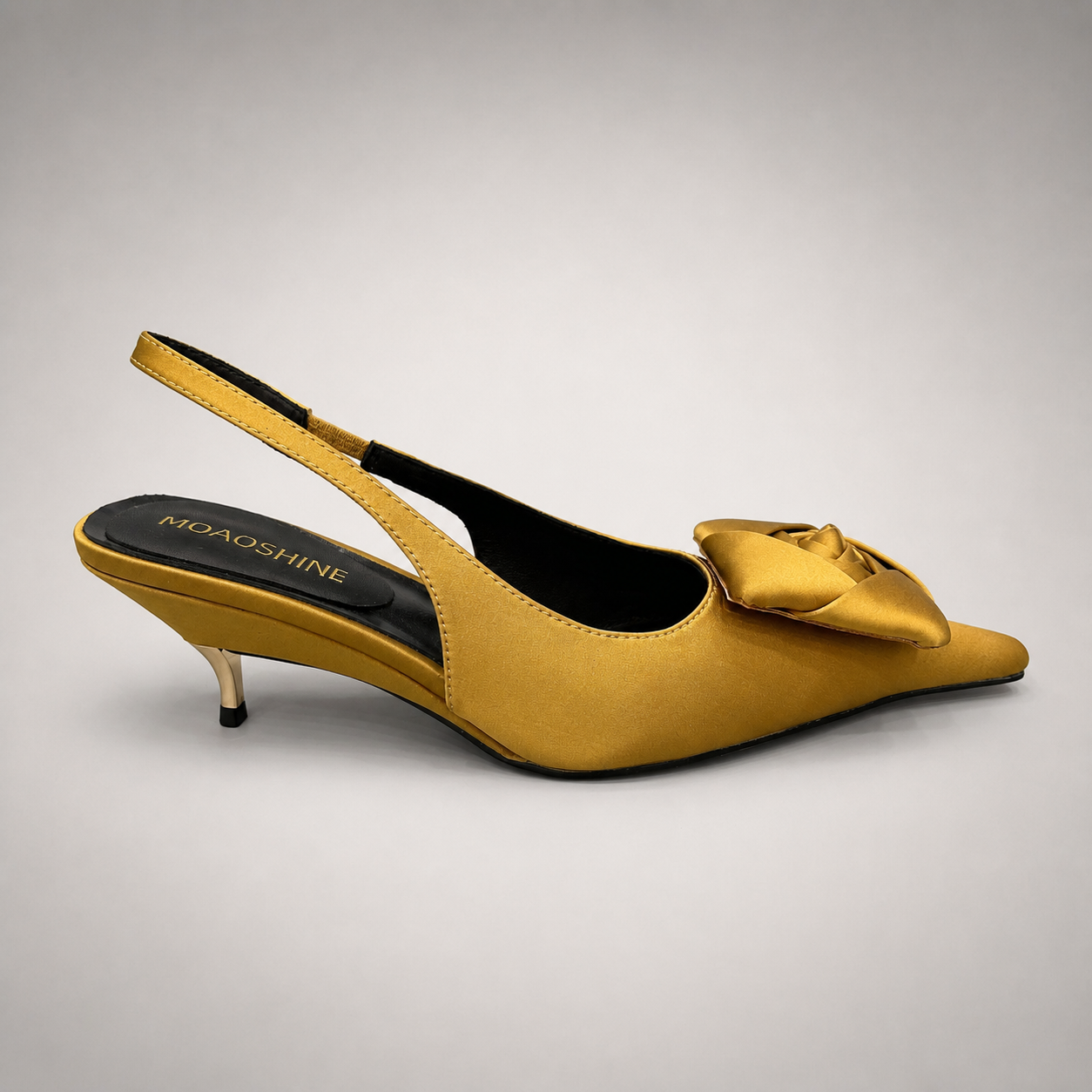 Gold slingback pump side profile showing a pointed toe and bow detail