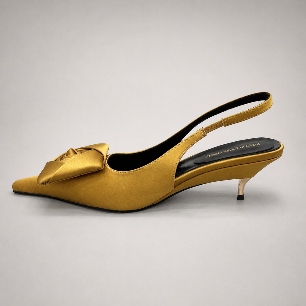 Gold slingback pump opposite side profile showing a pointed toe and bow detail