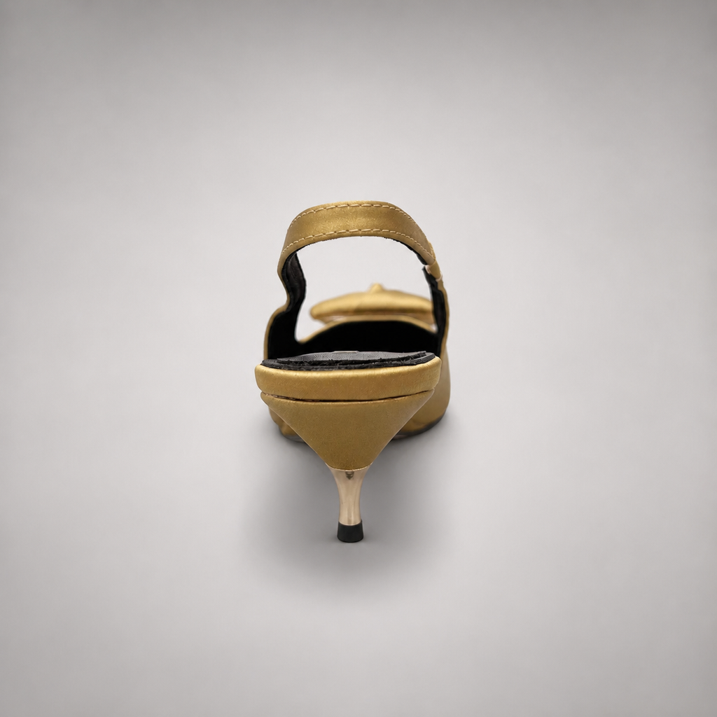 Gold slingback pump rear view showing a pointed toe and bow detail