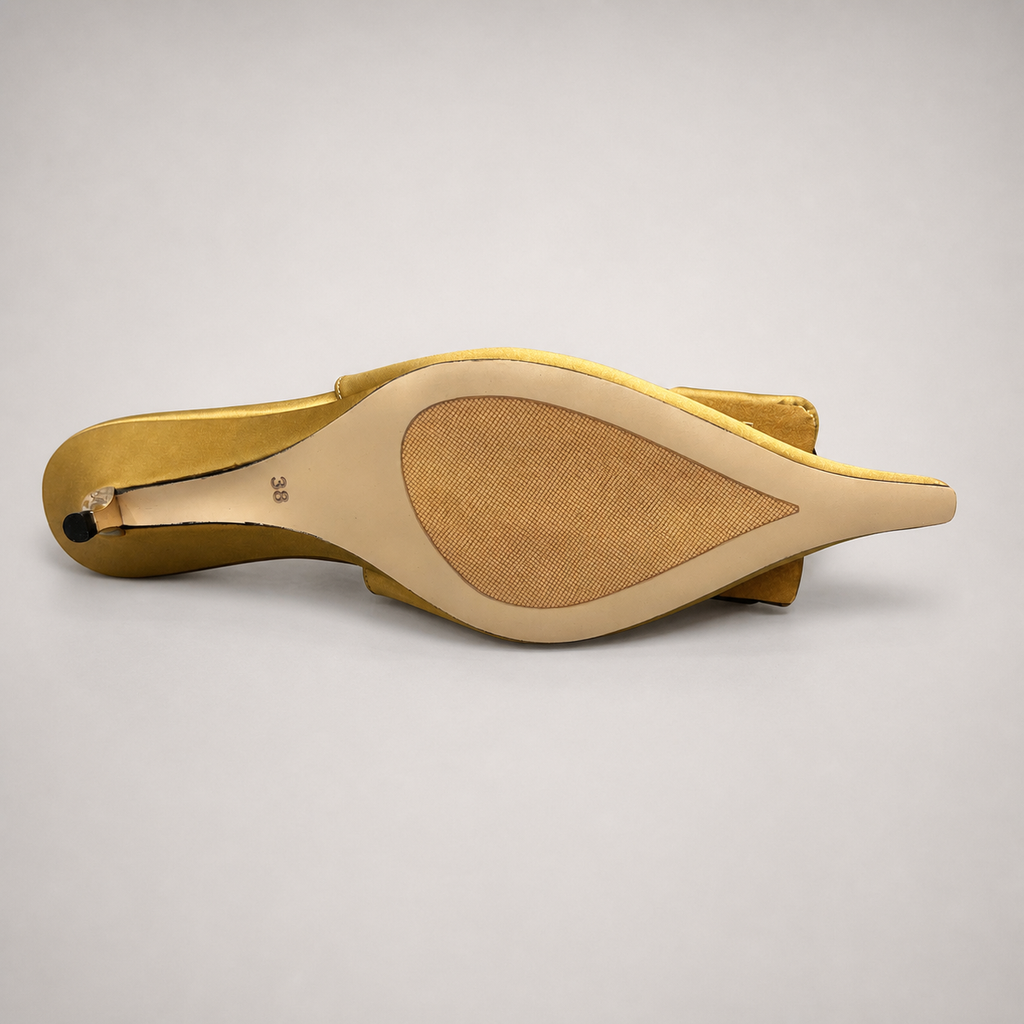 Gold slingback pump top view showing a pointed toe and bow detail