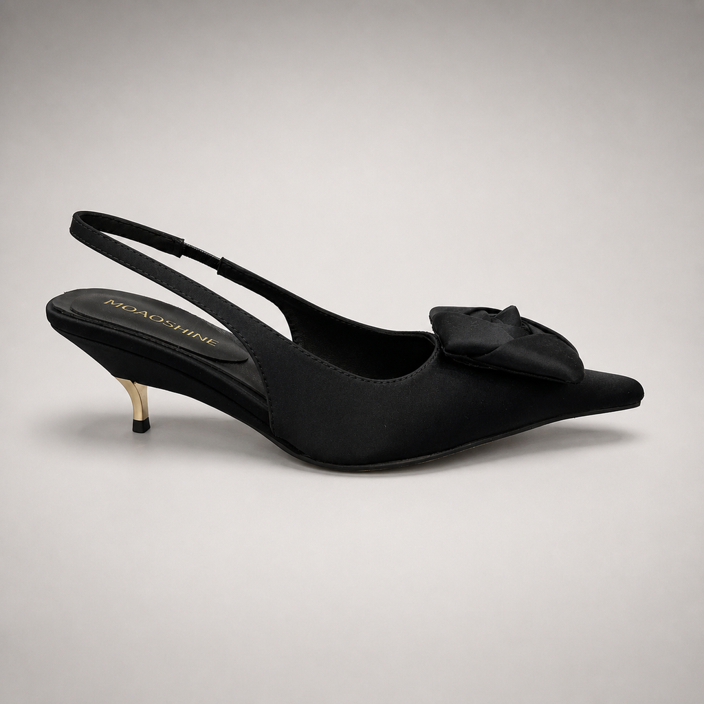 Black slingback pump side profile showing a pointed toe and bow detail