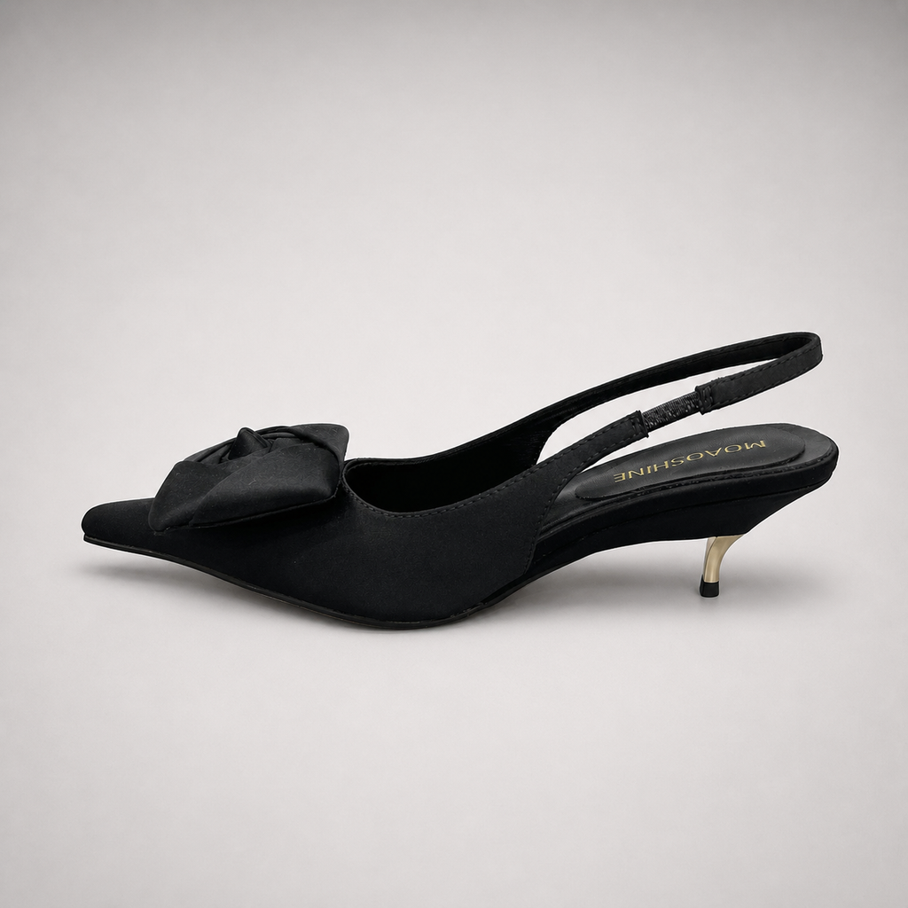 Black slingback pump opposite side profile showing a pointed toe and bow detail