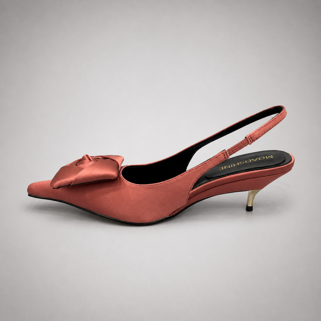 Pink slingback pump opposite side profile showing a pointed toe and bow detail
