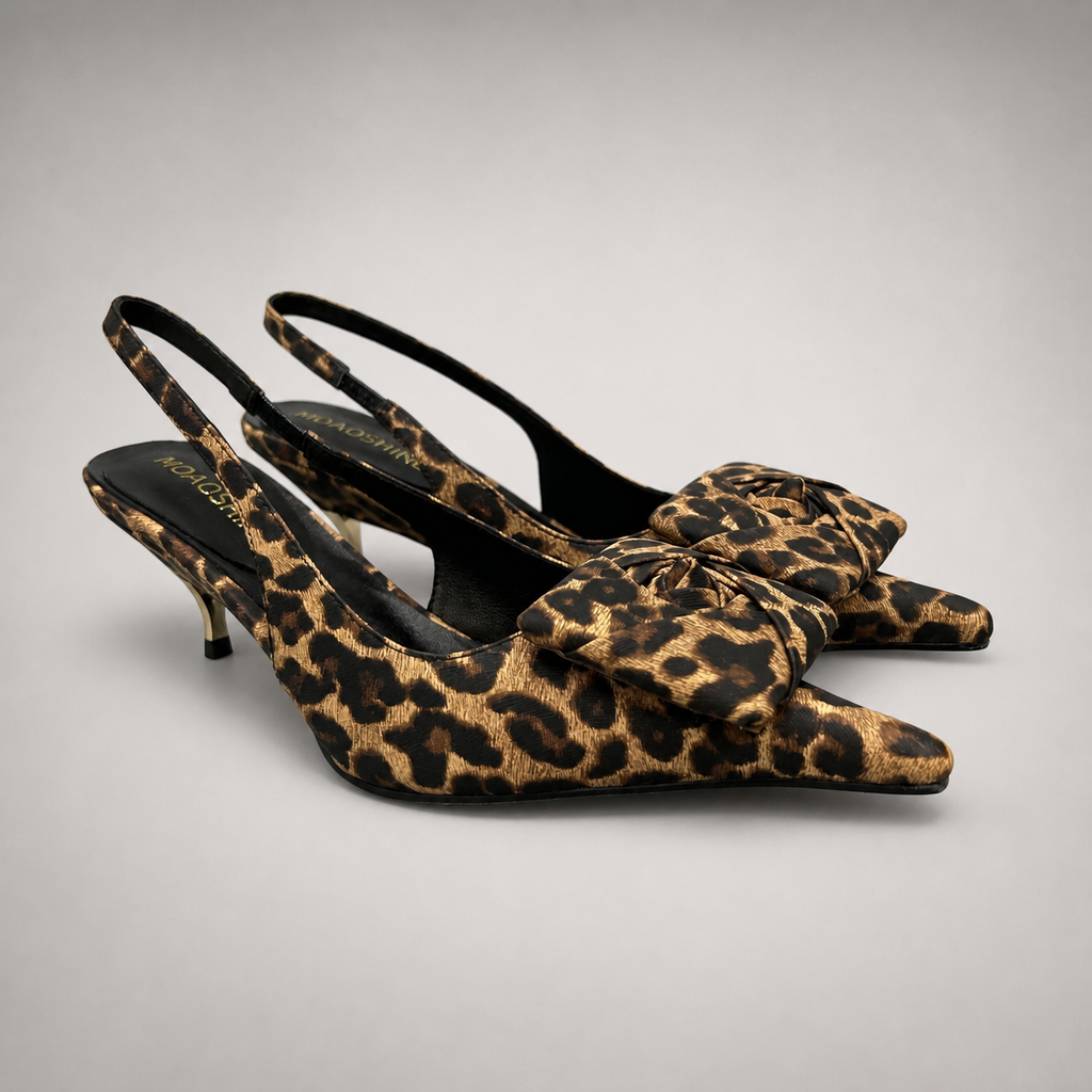 Brown slingback pump pair three-quarter view showing a leopard-print upper and bow detail
