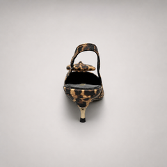 Brown slingback pump rear view showing a leopard-print upper and bow detail