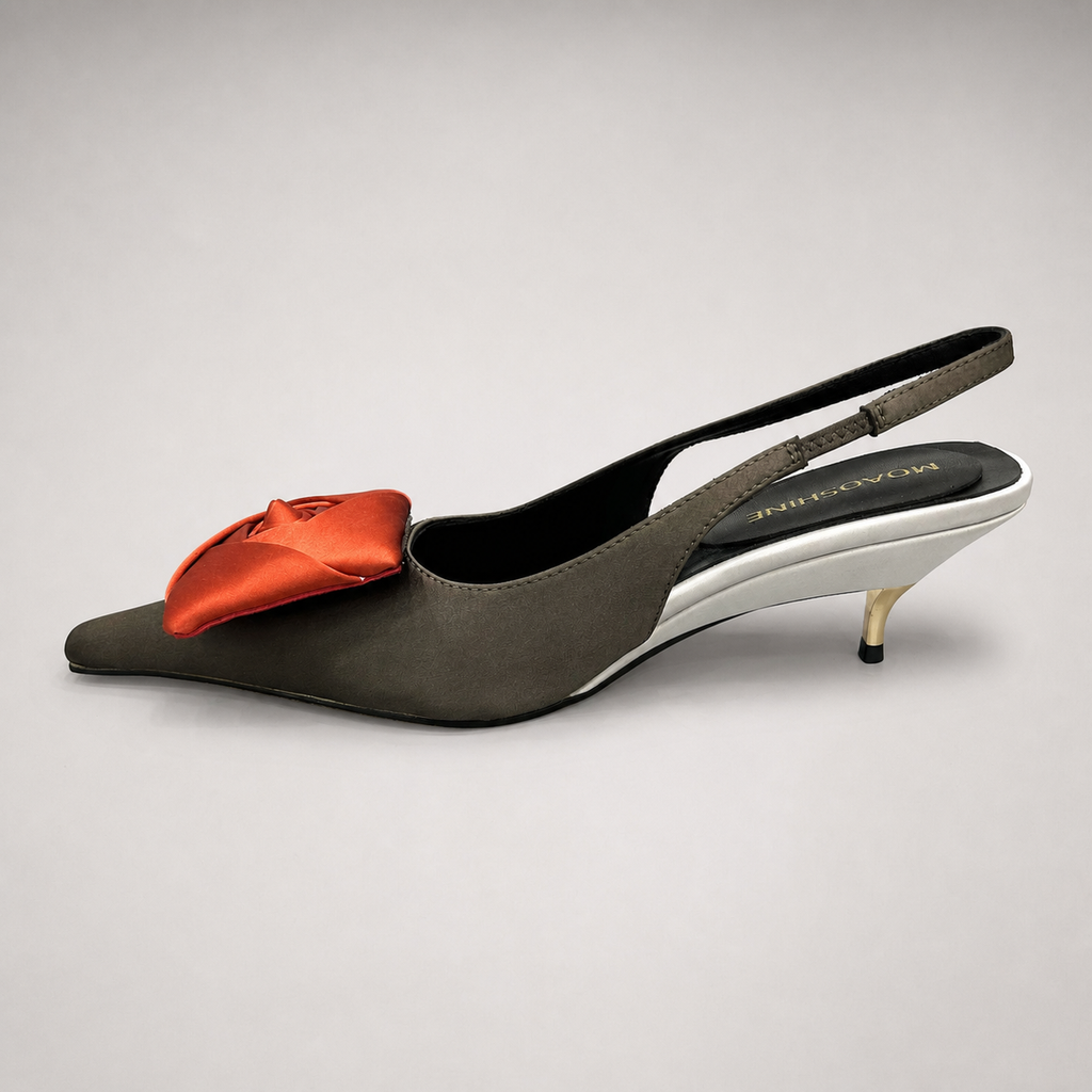 Black slingback pump opposite side profile showing a pointed toe and bow detail