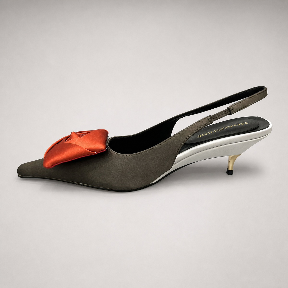 Black slingback pump opposite side profile showing a pointed toe and bow detail