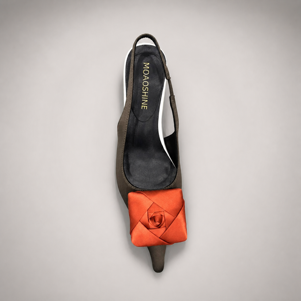 Black slingback pump rear view showing a pointed toe and bow detail