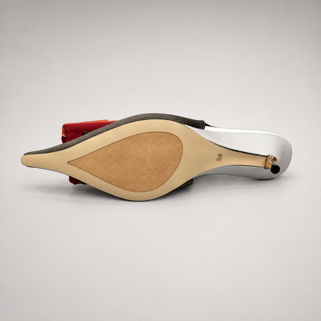 Black slingback pump top view showing a pointed toe and bow detail